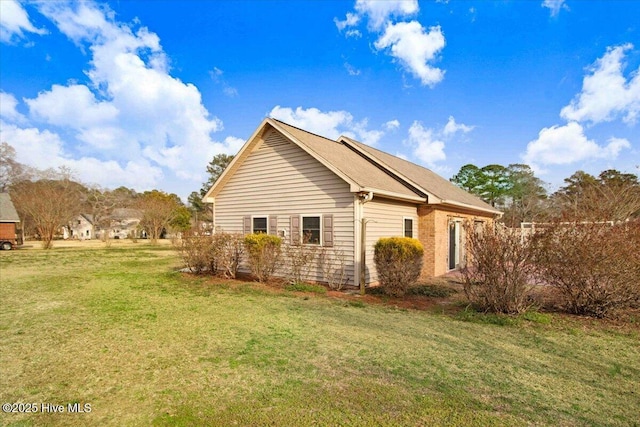 view of home's exterior featuring a yard