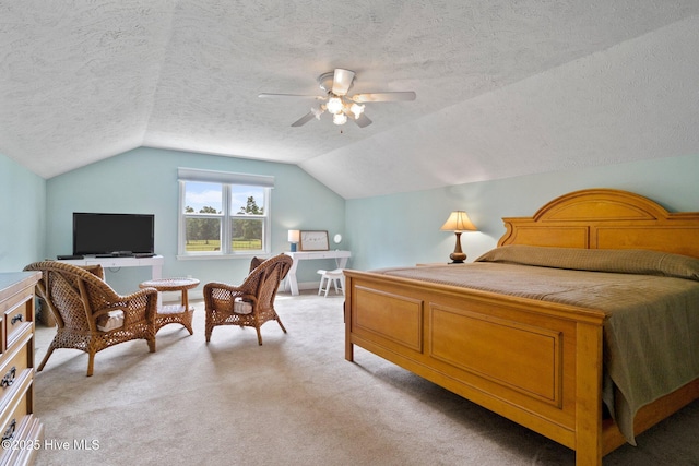 bedroom with light colored carpet, a textured ceiling, lofted ceiling, and a ceiling fan