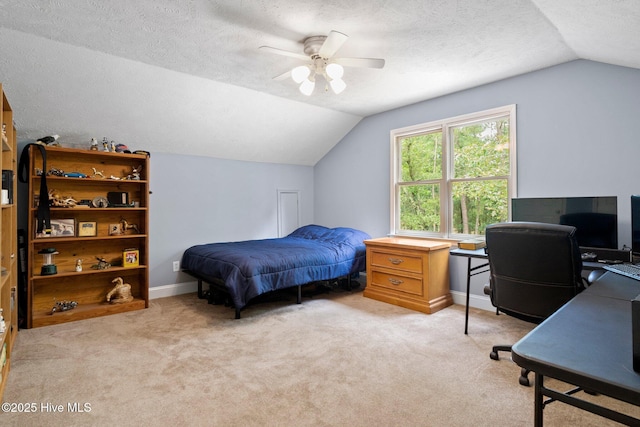 bedroom with light colored carpet, a textured ceiling, baseboards, and vaulted ceiling