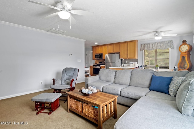 living area featuring baseboards, light carpet, ornamental molding, and a ceiling fan