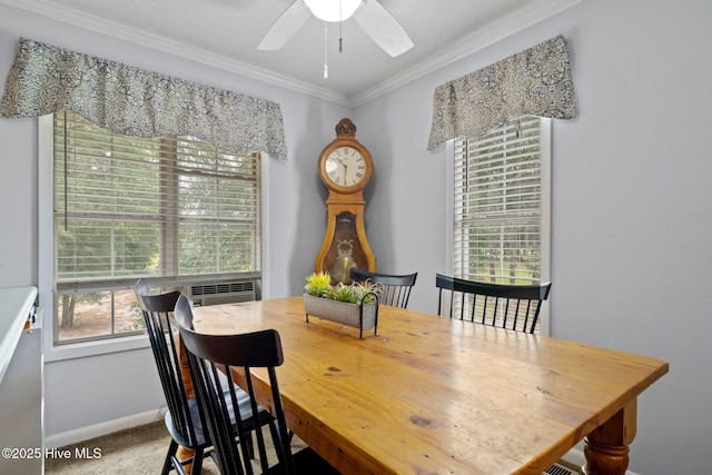 carpeted dining room with ceiling fan, cooling unit, baseboards, and ornamental molding