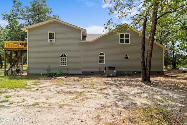 back of property with a wooden deck, central air condition unit, fence, and crawl space