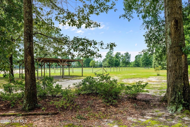 view of yard featuring a carport and fence