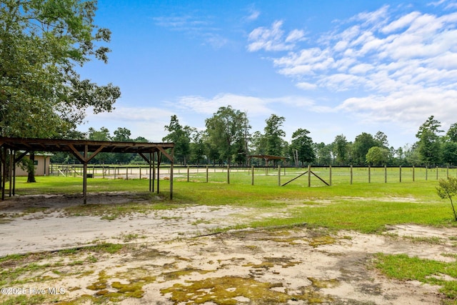 view of yard featuring an outbuilding and a rural view