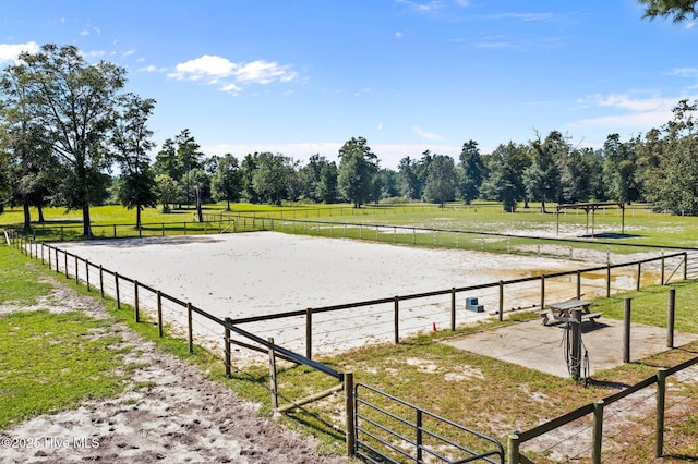 view of community with an enclosed area and a rural view