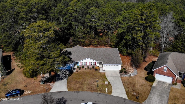 birds eye view of property with a forest view