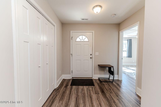 entryway featuring dark wood-style flooring, visible vents, and baseboards