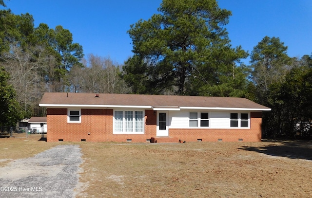 single story home featuring brick siding and crawl space