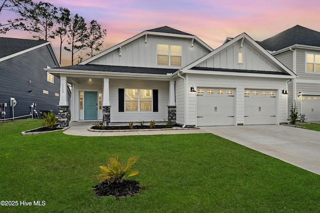 view of front facade with an attached garage, concrete driveway, board and batten siding, and a front yard