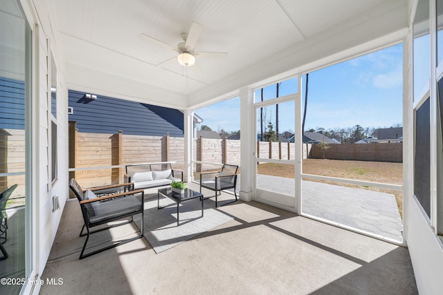 sunroom / solarium with a ceiling fan