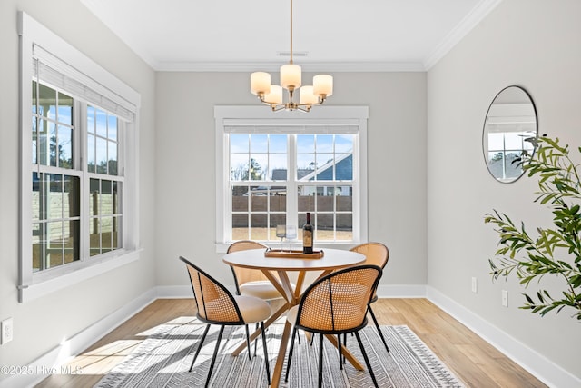 dining room with light wood finished floors, a wealth of natural light, and crown molding