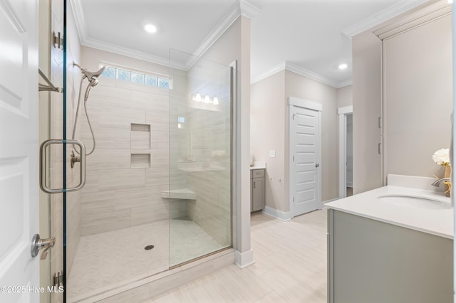 full bathroom with ornamental molding, a stall shower, vanity, and baseboards