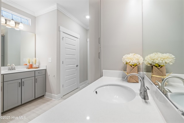 full bath featuring ornamental molding, vanity, and baseboards