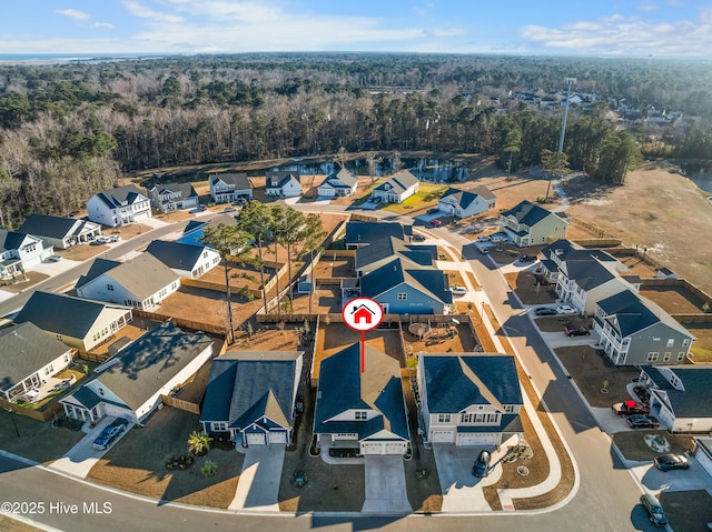 drone / aerial view with a forest view and a residential view