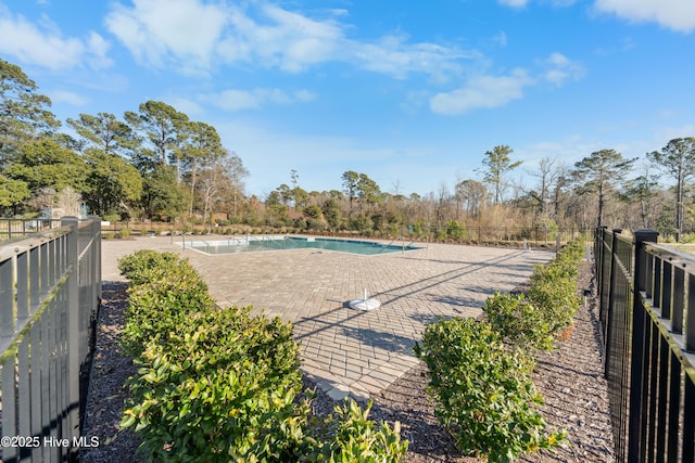 community pool featuring a patio area and fence