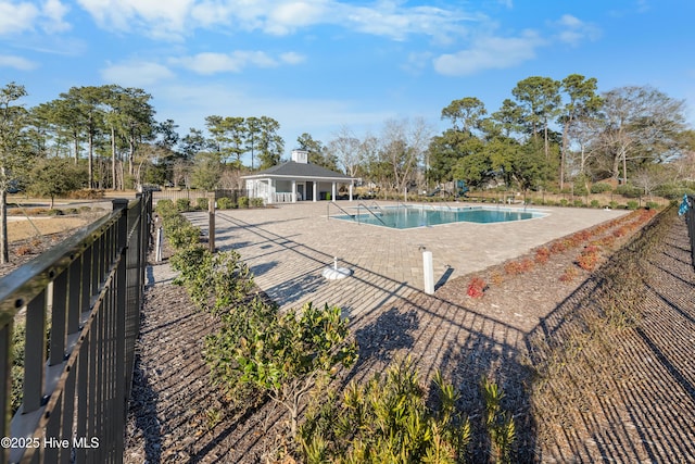 community pool featuring a patio area and fence