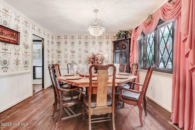 dining space featuring a wainscoted wall, hardwood / wood-style floors, and wallpapered walls