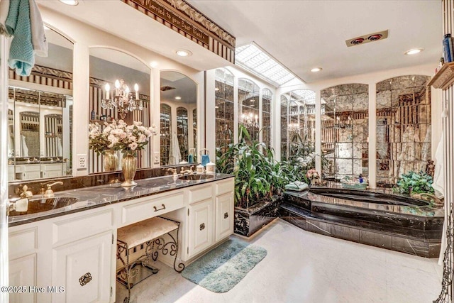 full bath featuring a garden tub, double vanity, a sink, and recessed lighting