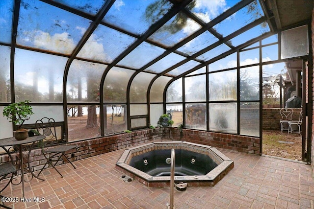 view of pool featuring a patio, an indoor in ground hot tub, and glass enclosure