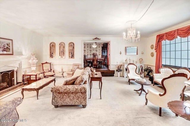 living area featuring crown molding, a chandelier, a fireplace with raised hearth, and carpet flooring