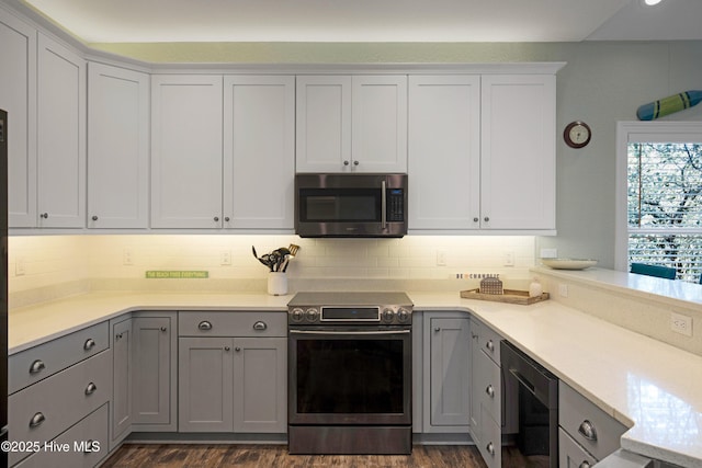 kitchen with decorative backsplash, wine cooler, appliances with stainless steel finishes, gray cabinets, and light countertops