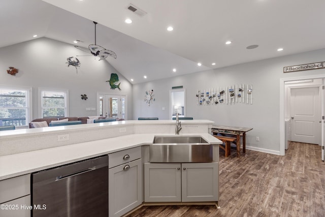 kitchen with dishwasher, ceiling fan, wood finished floors, light countertops, and a sink