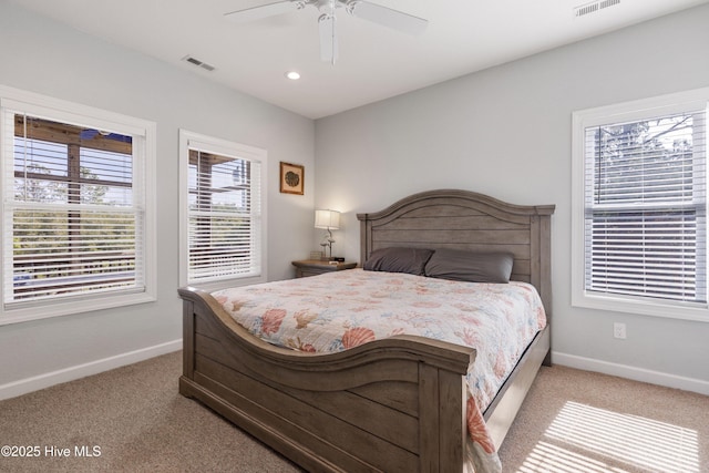 carpeted bedroom featuring ceiling fan, recessed lighting, visible vents, and baseboards