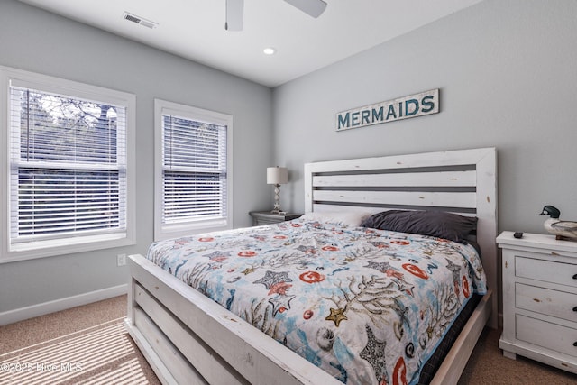 carpeted bedroom featuring baseboards, visible vents, and ceiling fan