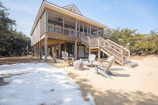 view of front facade with stairs, a patio area, a sunroom, and a ceiling fan