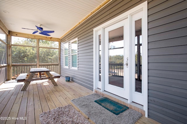 wooden terrace featuring a ceiling fan