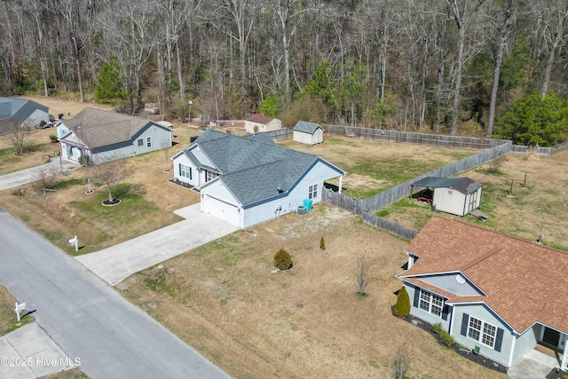 birds eye view of property with a view of trees