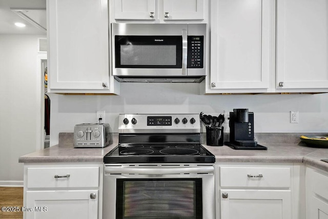 kitchen featuring white cabinetry, appliances with stainless steel finishes, and light countertops