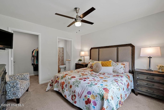 bedroom featuring baseboards, ensuite bath, a spacious closet, carpet flooring, and a closet