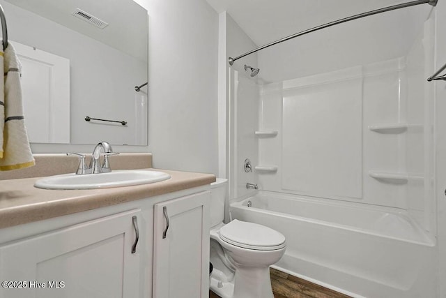 bathroom featuring shower / tub combination, toilet, wood finished floors, vanity, and visible vents