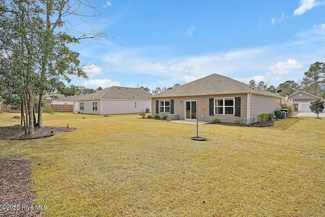 back of house with a lawn