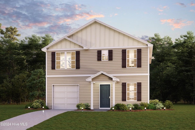 view of front facade featuring a yard, board and batten siding, an attached garage, and driveway