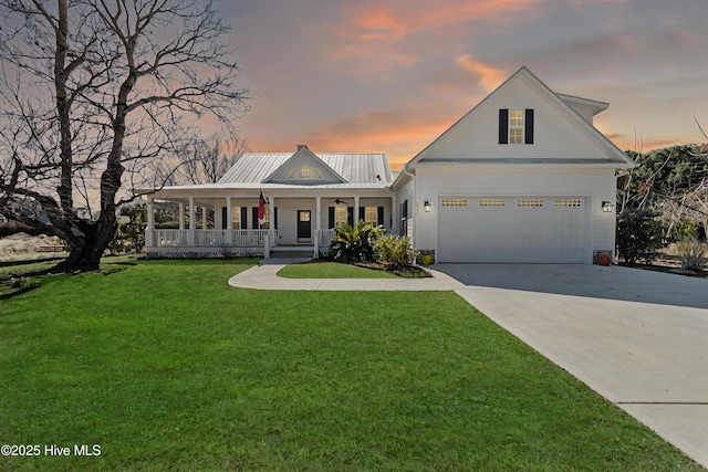 view of front facade featuring a ceiling fan, a yard, an attached garage, covered porch, and concrete driveway