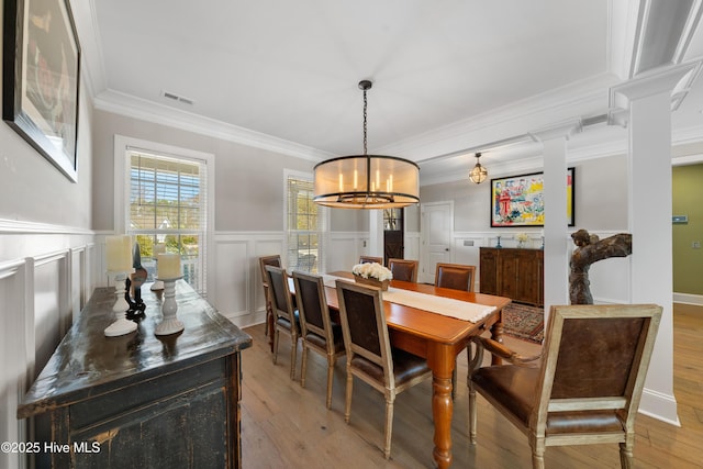 dining area featuring an inviting chandelier, visible vents, light wood finished floors, and ornamental molding