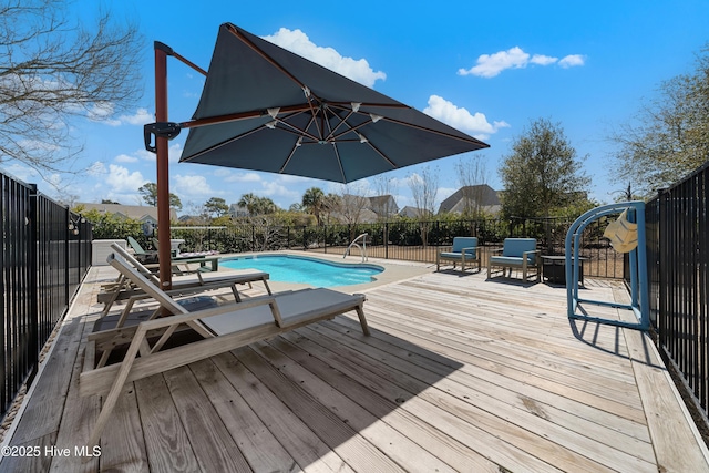 wooden terrace featuring a patio, a fenced in pool, and fence