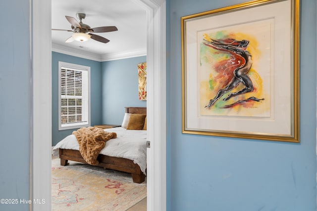 bedroom with a ceiling fan and crown molding