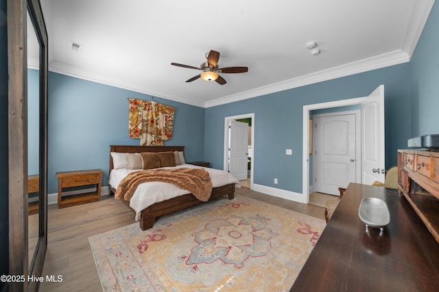 bedroom featuring ceiling fan, baseboards, light wood finished floors, and ornamental molding