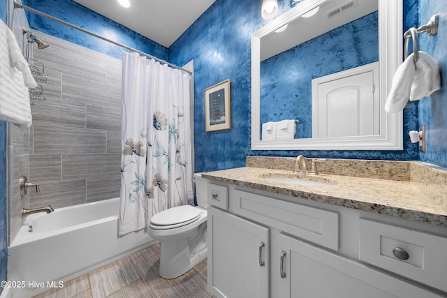 bathroom featuring vanity, toilet, visible vents, and shower / tub combo with curtain