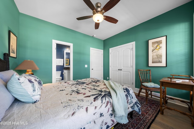 bedroom featuring a ceiling fan, wood finished floors, baseboards, a closet, and ensuite bathroom