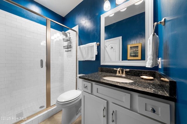 full bath featuring vanity, a shower stall, and toilet