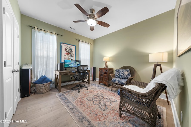 office area with visible vents, baseboards, a ceiling fan, and wood finished floors