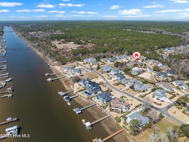 bird's eye view featuring a wooded view and a water view