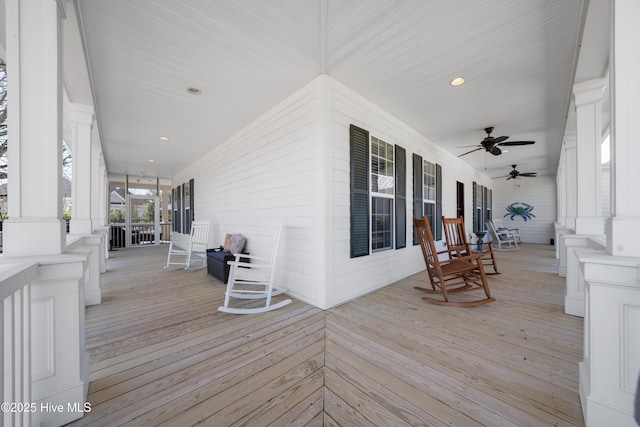 wooden terrace with a porch and ceiling fan