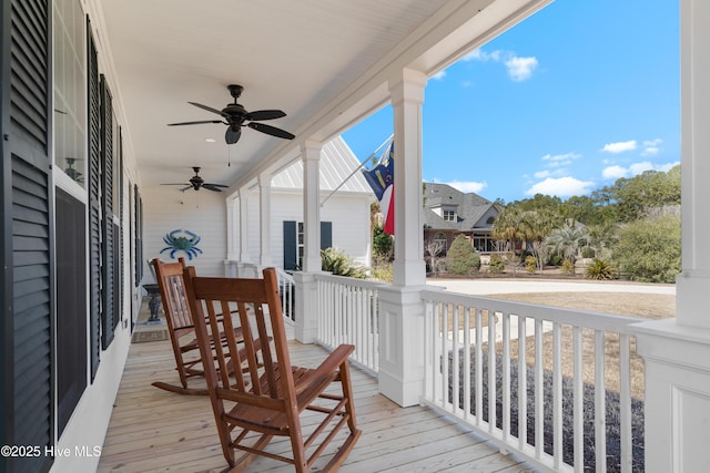 wooden deck with a residential view, covered porch, and a ceiling fan