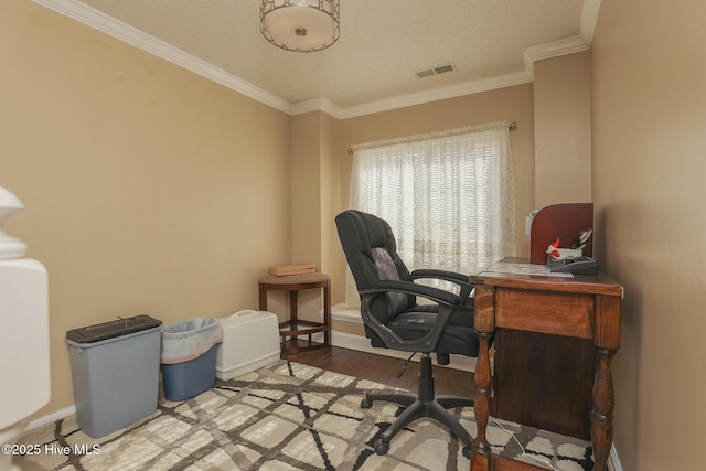 office space with ornamental molding, wood finished floors, visible vents, and baseboards