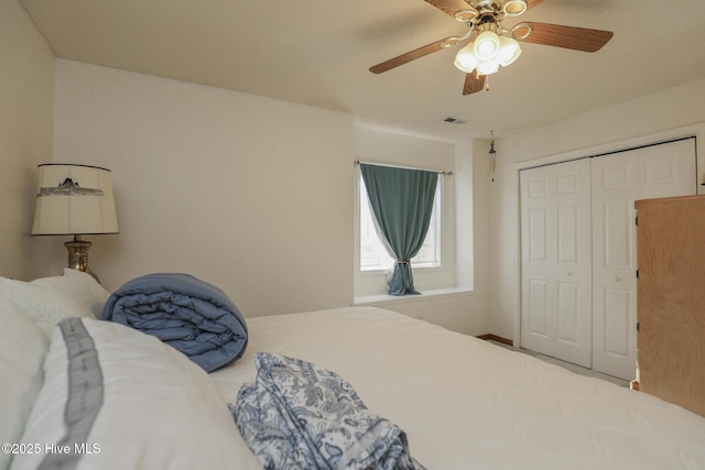 bedroom featuring ceiling fan, a closet, and visible vents